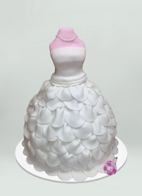 Photo: cake shaped like mannequin wearing a white layered wedding dress