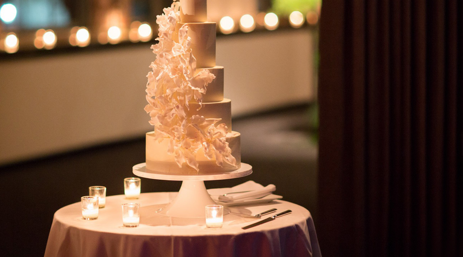 Photo: five tier smooth white wedding cake with cascading flowers