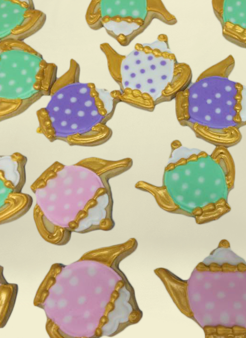 Photo: cookies shaped like tea pots and gold royal ice with dot pattern