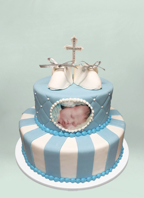 Photo: 2 tier fondant cake with fondant baby shoes and cross, photo of the baby
