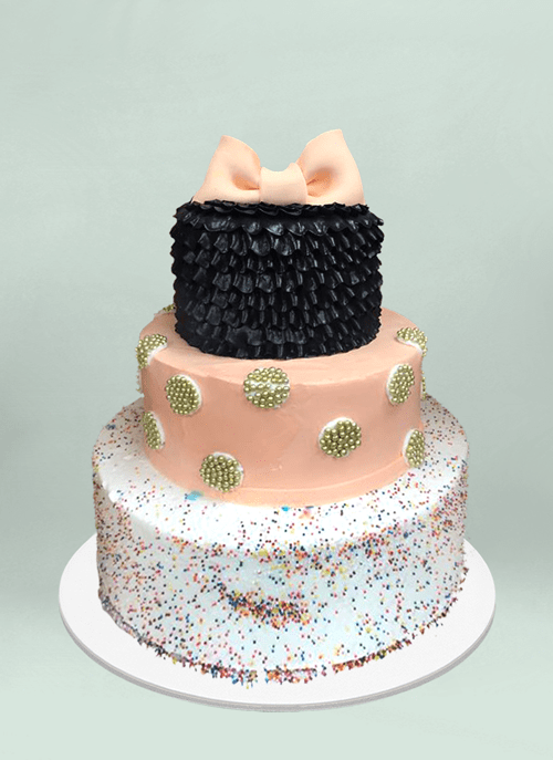 Photo: frosted cake, rainbow sprinkles, frosted texture and fondant bow on top tier