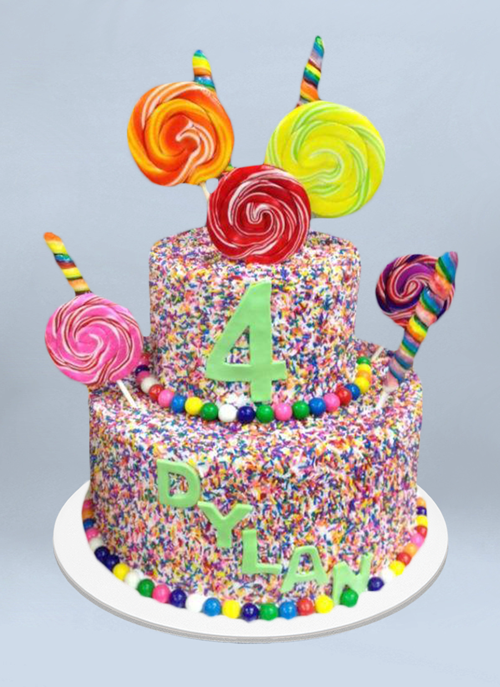 Photo: frosted cake with rainbow sprinkles and large spiral lollipops sticking out
