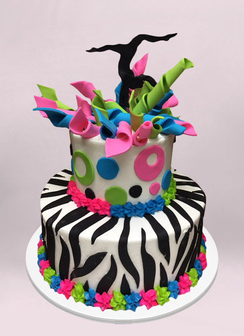Photo: zebra pattern cake with pink, green, blue ribbons and black dancer topper