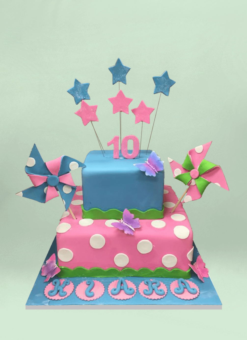 Photo: square fondant cake with fondant pinwheels and stars sticking out