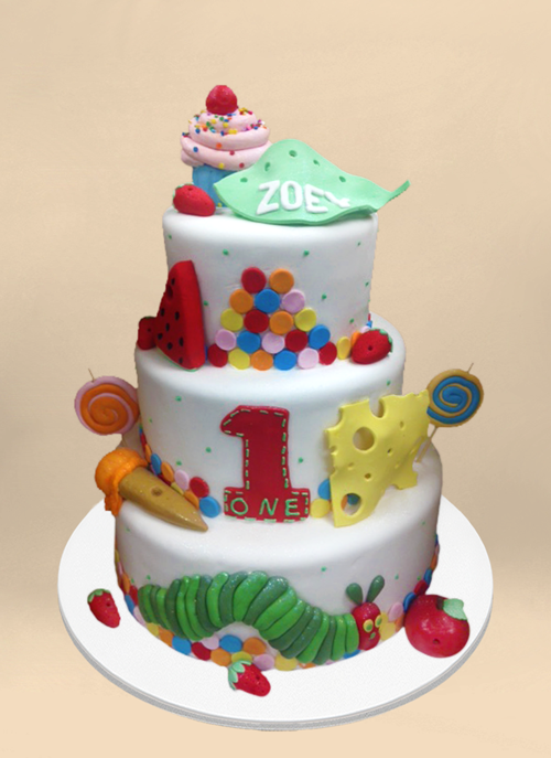 Photo: white fondant cake with fondant elements from Hungry Hungry Caterpillar around 3 tiers