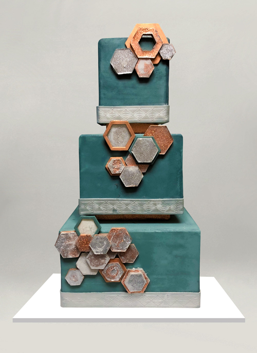 Photo: teal ckae with square tiers and Geometric shapes