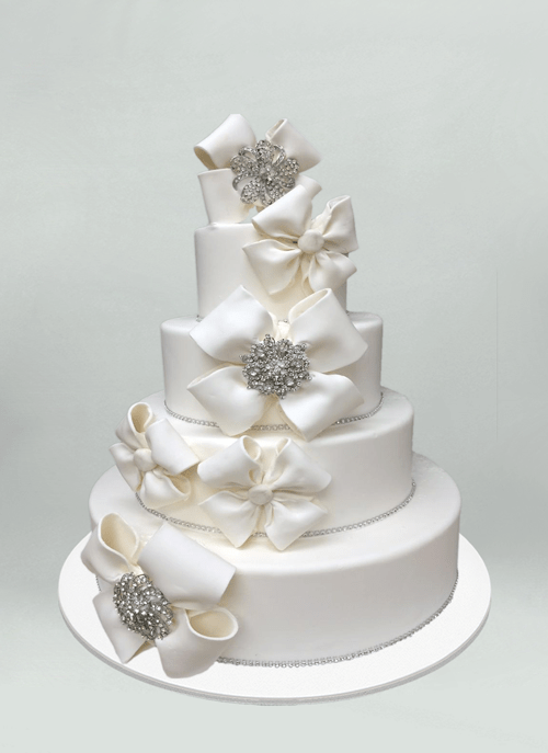 Photo: white fondant cake with cascading white bows and beaded accents
